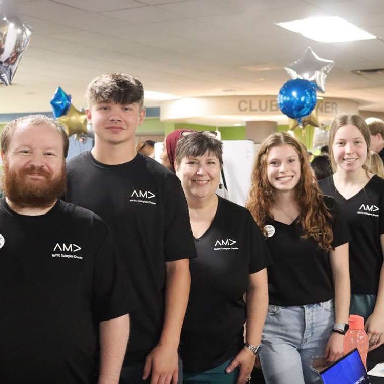 Group of 4 college student volunteers in black AMA shirts