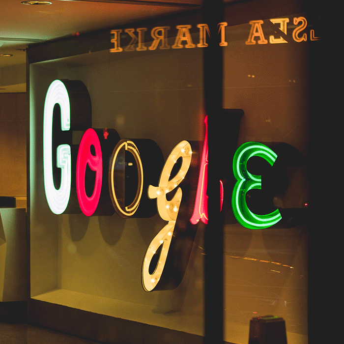 A sign from a Google office made up of mismatched letters spelling out "Google"